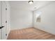 Bright bedroom with neutral carpet, a window, and a closet with black hardware at 6995 Tybridge St, Cumming, GA 30040