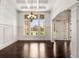 Elegant dining room features coffered ceilings, wainscoting, large windows, and a sophisticated chandelier at 6995 Tybridge St, Cumming, GA 30040