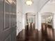 Bright foyer with hardwood floors, archways, and natural light streaming in from the living area and kitchen at 6995 Tybridge St, Cumming, GA 30040