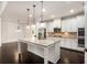 Bright, spacious kitchen with granite counters, stainless appliances, and pendant lighting at 6995 Tybridge St, Cumming, GA 30040