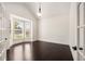 Bright living room boasts large windows, hardwood floors, french doors, and vaulted ceiling at 6995 Tybridge St, Cumming, GA 30040