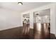 Expansive living space showcasing hardwood floors, open layout with views to the kitchen and dining area at 6995 Tybridge St, Cumming, GA 30040