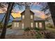 Back exterior of home featuring a well-maintained backyard and beautiful sunset at 2760 Lions Gate Dr, Cumming, GA 30041