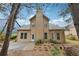 View of the house and backyard, featuring a chimney and small patio at 2760 Lions Gate Dr, Cumming, GA 30041