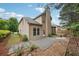 Back of house with a small patio and landscaped backyard at 2760 Lions Gate Dr, Cumming, GA 30041