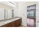 Bathroom featuring a dual sink vanity and an open doorway at 2760 Lions Gate Dr, Cumming, GA 30041
