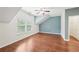 Bright bedroom featuring hardwood floors, a ceiling fan, and a large window with lots of natural light at 2760 Lions Gate Dr, Cumming, GA 30041