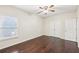Bedroom featuring hardwood floors, a ceiling fan, closet space, and a window with great natural light at 2760 Lions Gate Dr, Cumming, GA 30041