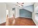 Bedroom with hardwood floors, a ceiling fan, a closet, and large window offering great natural light at 2760 Lions Gate Dr, Cumming, GA 30041