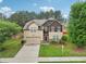 Inviting two-story home with a well-manicured lawn and attached two-car garage at 2760 Lions Gate Dr, Cumming, GA 30041