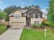 Well-maintained two-story home with a two-car garage and landscaped front yard at 2760 Lions Gate Dr, Cumming, GA 30041