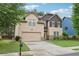 Two-story home with a two-car garage, green lawn, and mature landscaping at 2760 Lions Gate Dr, Cumming, GA 30041