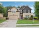Two-story home with a two-car garage and well-maintained lawn and landscaping at 2760 Lions Gate Dr, Cumming, GA 30041