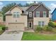 Two-story home with a two-car garage and landscaped front yard at 2760 Lions Gate Dr, Cumming, GA 30041