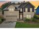 Charming two-story home with a two-car garage, manicured lawn and lovely landscaping at 2760 Lions Gate Dr, Cumming, GA 30041