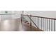 Bright hallway featuring hardwood floors and a staircase with iron balusters at 2760 Lions Gate Dr, Cumming, GA 30041