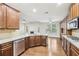 Kitchen showcases granite counters, stainless appliances, hardwood floors, and eat-in breakfast area at 2760 Lions Gate Dr, Cumming, GA 30041