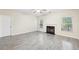 Living room with light wood floors, fireplace, ceiling fan, and natural light at 2760 Lions Gate Dr, Cumming, GA 30041