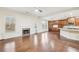 Open living room with a fireplace flowing to a modern kitchen at 2760 Lions Gate Dr, Cumming, GA 30041