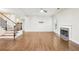 Open living room with hardwood floors, fireplace, and staircase at 2760 Lions Gate Dr, Cumming, GA 30041