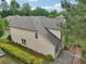 Aerial view of a home's rear exterior, showcasing its siding, roof, and manicured landscaping at 2760 Lions Gate Dr, Cumming, GA 30041
