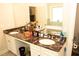 Bathroom featuring double sinks, dark countertops, white cabinetry, and a soaking tub at 305 Anise Ct, Mcdonough, GA 30252