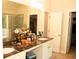 Bathroom with dual sink vanity, marble countertop, large mirror, and walk-in closet at 305 Anise Ct, Mcdonough, GA 30252
