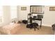 Well-lit room is shown with a comfy ottoman and desk at 305 Anise Ct, Mcdonough, GA 30252