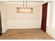 Empty dining room with modern pendant lighting and wainscoting at 305 Anise Ct, Mcdonough, GA 30252