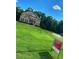 Brick two-story home with lush front lawn and 'For Sale' sign at 305 Anise Ct, Mcdonough, GA 30252