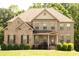 Charming brick home with well-maintained landscaping and inviting front porch at 305 Anise Ct, Mcdonough, GA 30252