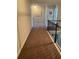 Well-lit hallway with carpet flooring and a dark wooden railing leading to other rooms at 305 Anise Ct, Mcdonough, GA 30252