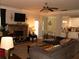 Spacious living room with a fireplace, piano and open layout to the kitchen and dining areas at 305 Anise Ct, Mcdonough, GA 30252