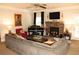 Cozy living room with fireplace, piano, and comfortable gray sofa at 305 Anise Ct, Mcdonough, GA 30252