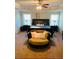 Main bedroom featuring a large bed, ceiling fan, tray ceiling and reading nook at 305 Anise Ct, Mcdonough, GA 30252