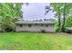 Wide shot of the backyard showing the house and green lawn at 3197 Ward Sw Dr, Atlanta, GA 30354