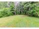 Large backyard with lush green grass and surrounding trees offering privacy at 3197 Ward Sw Dr, Atlanta, GA 30354