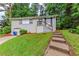 Charming home featuring a brick facade, landscaped front yard and stairway leading to the main entry at 3197 Ward Sw Dr, Atlanta, GA 30354