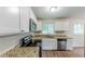 Well-lit kitchen featuring white cabinets, granite countertops, and stainless steel appliances at 3197 Ward Sw Dr, Atlanta, GA 30354