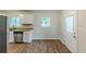 Well-lit kitchen featuring stainless steel appliances, granite countertops and white cabinets at 3197 Ward Sw Dr, Atlanta, GA 30354