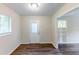 Hardwood flooring in open concept space with window and white door at 3197 Ward Sw Dr, Atlanta, GA 30354
