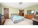 Bright bedroom featuring neutral carpet, olive walls, and soft furnishings including a comfy bed and side table at 3497 Highway 5, Douglasville, GA 30135