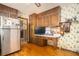 Spacious kitchen with stainless steel refrigerator, breakfast bar, and vintage wall decor. Hardwood floors at 3497 Highway 5, Douglasville, GA 30135