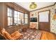 Cozy living room with wood paneled walls, large windows, and vintage decor with two lounging chairs and a TV at 3497 Highway 5, Douglasville, GA 30135