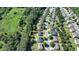 An aerial view of a property in a wooded neighborhood, outlined in yellow, showing its location and surrounding greenery at 645 Earlham Dr, Suwanee, GA 30024