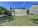 View of the home's green backyard with a patio and partial fence at 645 Earlham Dr, Suwanee, GA 30024