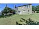 Backyard featuring lush green grass, mature trees, and partial view of house at 645 Earlham Dr, Suwanee, GA 30024