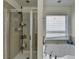 Modern bathroom with glass-enclosed shower and separate soaking tub with chrome fixtures at 645 Earlham Dr, Suwanee, GA 30024