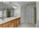 Bathroom with double sink vanity, tile floor, and large mirror reflecting the shower at 645 Earlham Dr, Suwanee, GA 30024