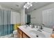 Bright bathroom features double sinks and a colorful shower curtain at 645 Earlham Dr, Suwanee, GA 30024